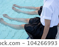 A high school girl sitting by the pool in uniform 104266993