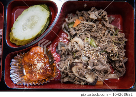 A lunch box containing rice, meat, fish, vegetables, kimchi, tempura, fruit, etc. 104268681