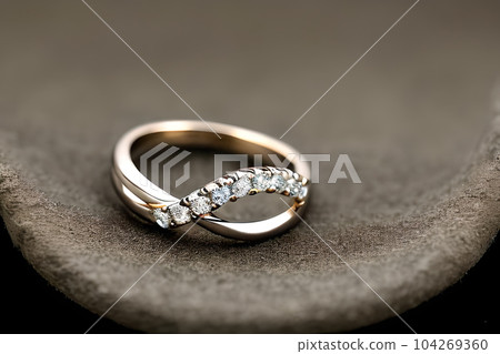 stunning close up shot of a single wedding rings, delicately intertwined to symbolize the everlasting bond of love and commitment. Jewelry gold diamond ring for anniversary, valentine, or engagement. 104269360