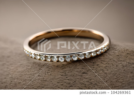 stunning close up shot of a single wedding rings, delicately intertwined to symbolize the everlasting bond of love and commitment. Jewelry gold diamond ring for anniversary, valentine, or engagement. 104269361