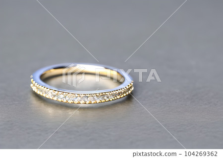 stunning close up shot of a single wedding rings, delicately intertwined to symbolize the everlasting bond of love and commitment. Jewelry gold diamond ring for anniversary, valentine, or engagement. 104269362