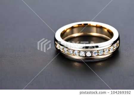 stunning close up shot of a single wedding rings, delicately intertwined to symbolize the everlasting bond of love and commitment. Jewelry gold diamond ring for anniversary, valentine, or engagement. 104269392