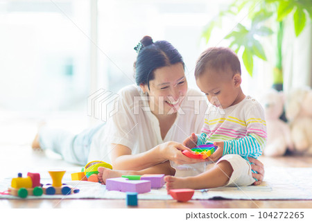Baby boy playing with toy 104272265