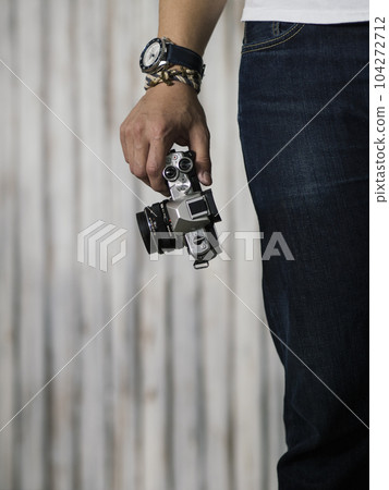 Right hand holding camera with watch and bracelet Right hand holding camera with watch and bracelet 104272712