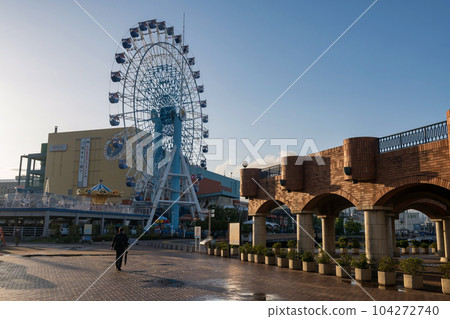 Businessman walking to s-pulse dream plaza at sunset, Shimuzu 104272740