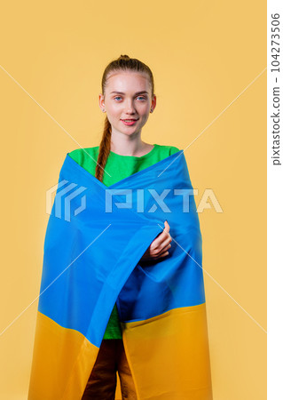 Happy woman with national Ukrainian flag on yellow. Ukraine,patriot, victory war Happy woman with national Ukrainian flag on yellow. Ukraine,patriot, victory war 104273506