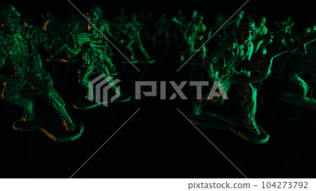 Military toys at war reconstruction,soldiers figures before battle black surface 104273792