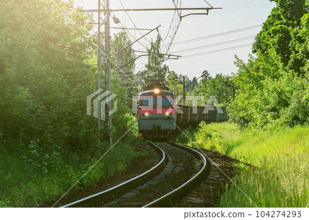 Freight train moves by the forest at spring day time. Freight train moves by the forest at spring day time. 104274293
