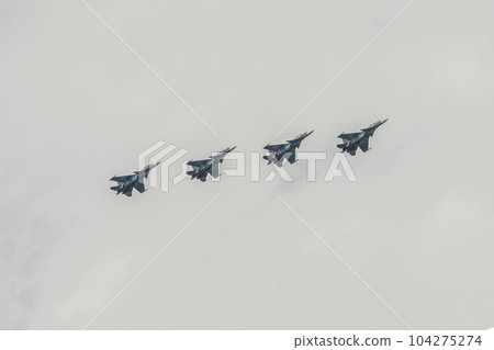 Four multi-purpose fighters SU-27 in the cloudy sky. Four multi-purpose fighters SU-27 in the cloudy sky. 104275274