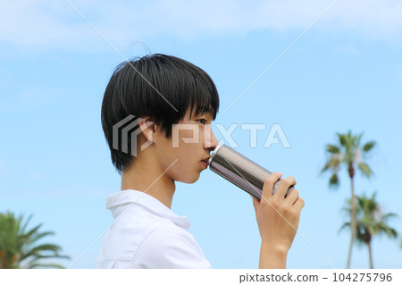 man drinking water from a mug man drinking water from a mug 104275796