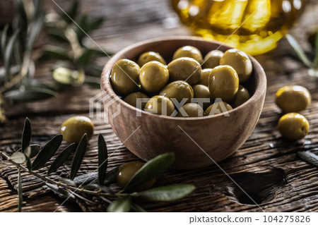 Green olives from mediterranean are served in wooden bowl 104275826