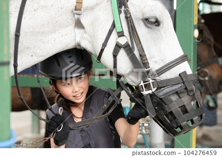 child taking care of horse 104276459