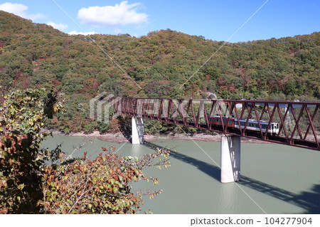 A train running on the Yunishigawa Bridge on the Aizu Kinugawa Line during the fall foliage season A train running on the Yunishigawa Bridge on the Aizu Kinugawa Line during the fall foliage season 104277904