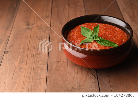 Spanish tomato cold gazpacho soup in bowl with basil. Homemade gazpacho prepared by red tomatoes. Copy space. Spanish tomato cold gazpacho soup in bowl with basil. Homemade gazpacho prepared by red tomatoes. Copy space. 104278803