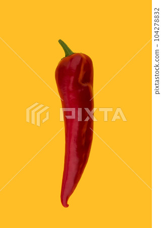 Red Ramiro Pepper on a yellow background. Ripe juicy appetizing long red pepper isolated on yellow. Vegetable Vegetarian Minimal Concept. Red Ramiro Pepper on a yellow background. Ripe juicy appetizing long red pepper isolated on yellow. Vegetable Vegetarian Minimal Concept. 104278832