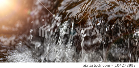 Fresh Water running down the River Stream around the smooth rocks. 104278992