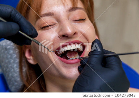 Pretty girl smiling at the dentist 104279042