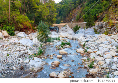Ancient stone bridge across a mountain river in Kesme Bogaz canyon, Antalya province in Turkey 104279054
