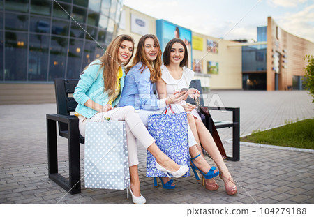 Beautiful girls with packages after shopping. Girl walking around city after shopping. good mood. 104279188