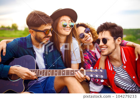 Group of friends enjoying party.people are are holding christmas sparklers in their hands. Group of friends enjoying party.people are are holding christmas sparklers in their hands. 104279233