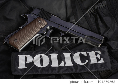 Police handgun on black uniform 104279268