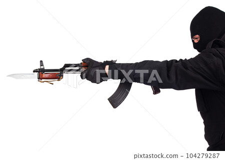 A man in a black uniform attacks with a bayonet. 104279287