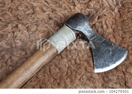 Viking battle axe on sheep fur Viking battle axe on sheep fur 104279301