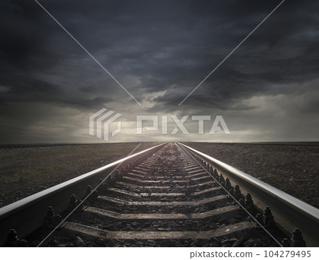 rails going away into the landscape distance 104279495
