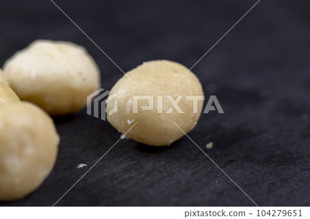 Peeled macadamia nuts on the table 104279651