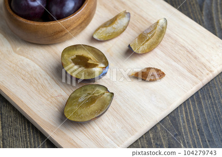 Ripe plums on the table in the kitchen Ripe plums on the table in the kitchen 104279743