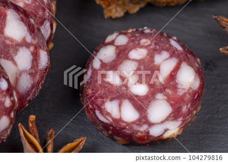 sliced high-quality pork sausage with the addition of lard pieces sliced high-quality pork sausage with the addition of lard pieces 104279816