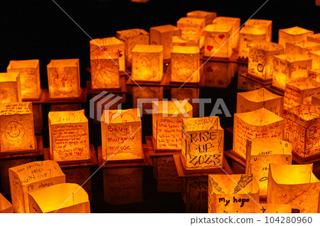 Wall of glowing golden Japanese style lanterns at festival Wall of glowing golden Japanese style lanterns at festival 104280960