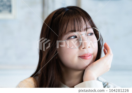 Close-up of a young woman wearing glasses Close-up of a young woman wearing glasses 104281226