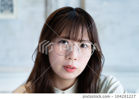 Close-up of a dissatisfied young woman wearing glasses 104281227
