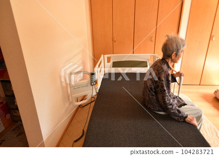 Elderly person sitting on a nursing bed 104283721