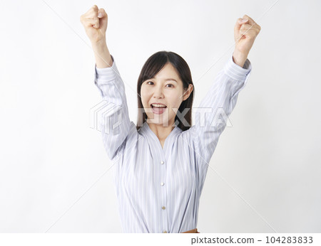 Middle-aged woman doing a guts pose White background Middle-aged woman doing a guts pose White background 104283833