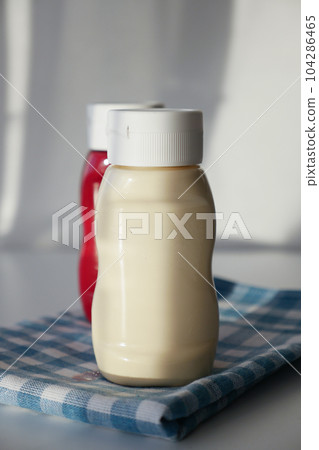 close up of Mayonnaise in container on table . 104286465