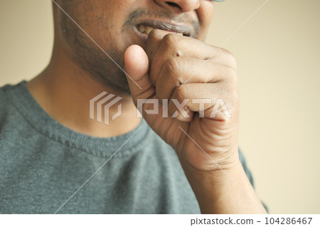 young sick man coughing and sneezes  104286467