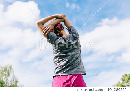 Sports woman stretching Sports woman stretching 104289211