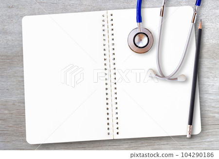 Notepad or notebook with pencil on brown wood table background.using wallpaper for education, business photo.Take note of the product for book with paper and concept Notepad or notebook with pencil on brown wood table background.using wallpaper for education, business photo.Take note of the product for book with paper and concept 104290186