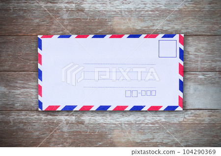 Top view with air mail envelope on the wood table 104290369