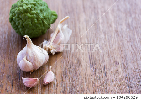 Top view of garlic on wood table background with copy space for design. Top view of garlic on wood table background with copy space for design. 104290629