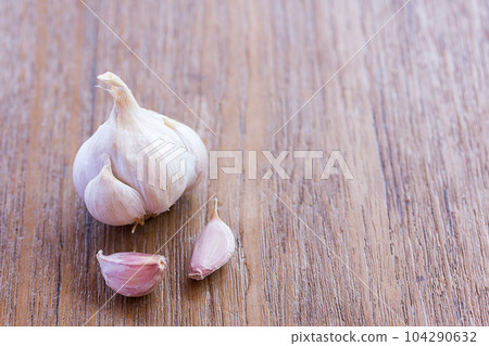 Top view of garlic on wood table background with copy space for design. Top view of garlic on wood table background with copy space for design. 104290632