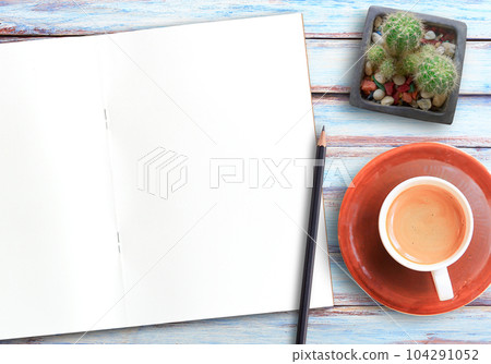 blank notebook and coffee on wood table with pencil 104291052