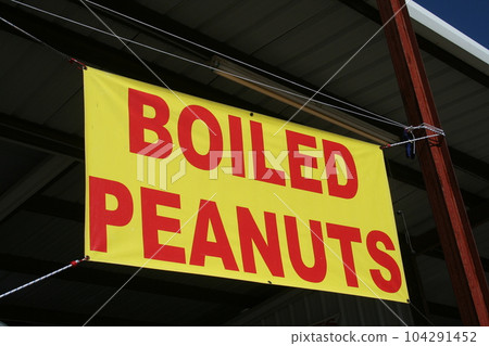 Red and Yellow Sign Advertising Boiled Peanuts 104291452