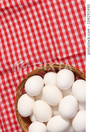 Basket of Farm Fresh Eggs on Red and White Checkered Fabric 104291498