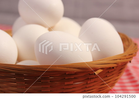 Basket of Farm Fresh Eggs on Red and White Checkered Fabric 104291500