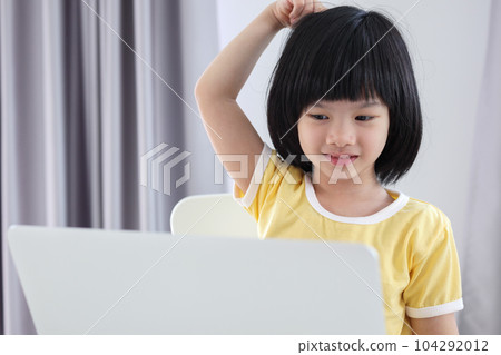 little asian girl student study online using laptop computer at home 104292012