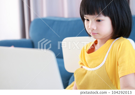 little asian girl student study online using laptop computer at home 104292013
