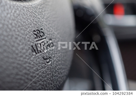 Safety airbag sign on car steering wheel with horn icon 104292384